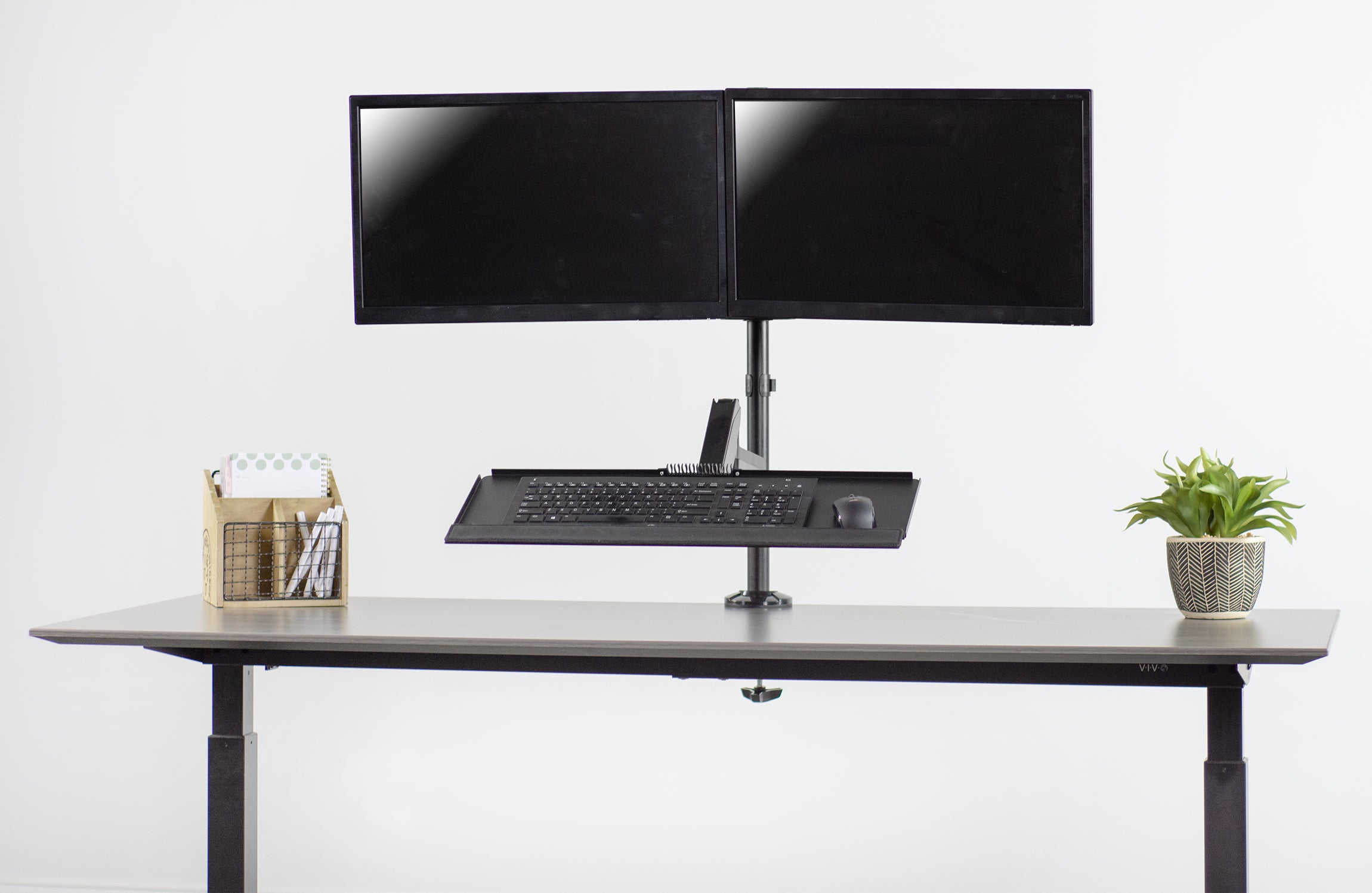 Sturdy ergonomic dual monitor sit to stand wall mount workstation.