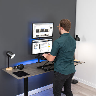 Sturdy adjustable vertical dual monitor ergonomic desk mount for office workstation.