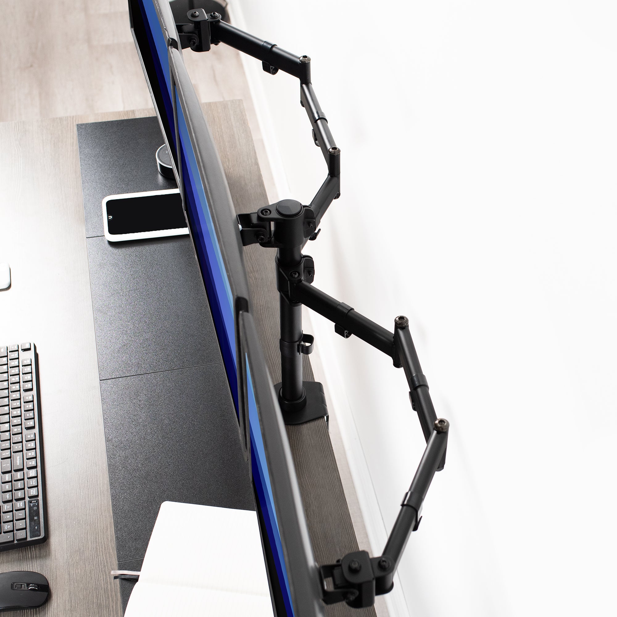 Sturdy height adjustable triple monitor desk mount.