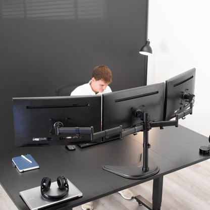 Sturdy height adjustable triple monitor desk stand.