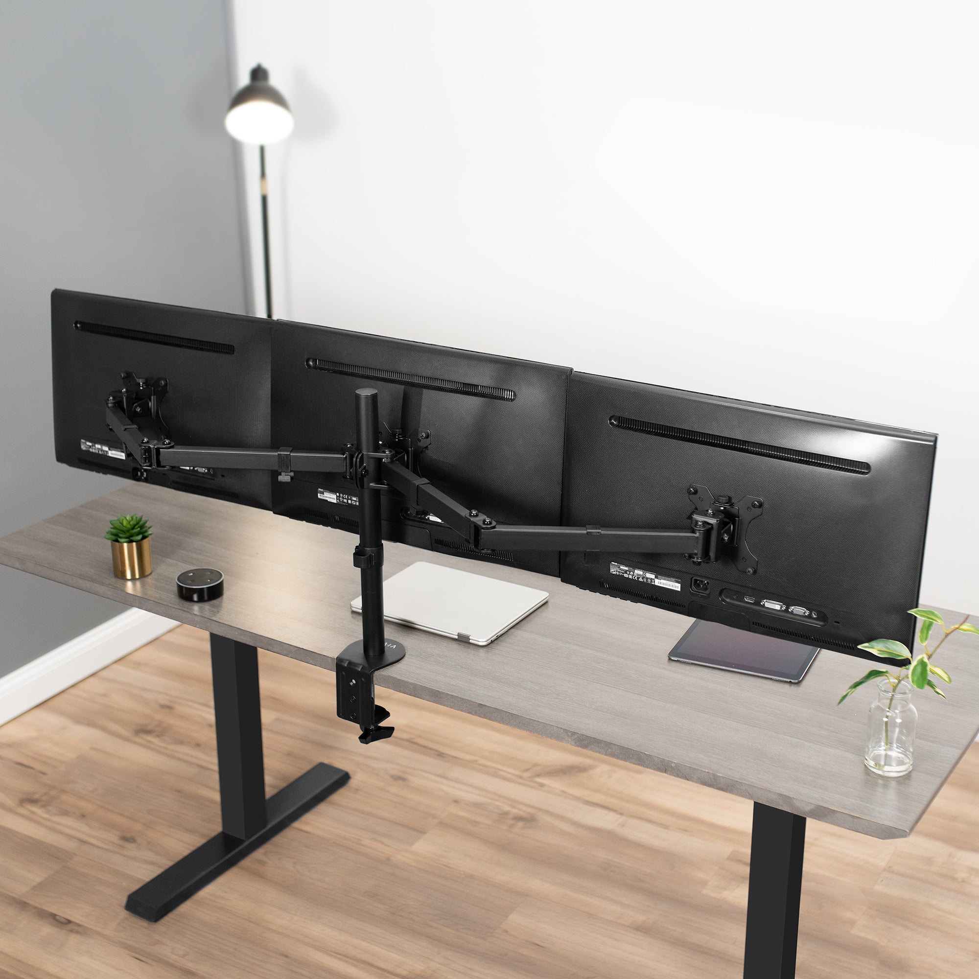 Sturdy height adjustable triple monitor desk mount.