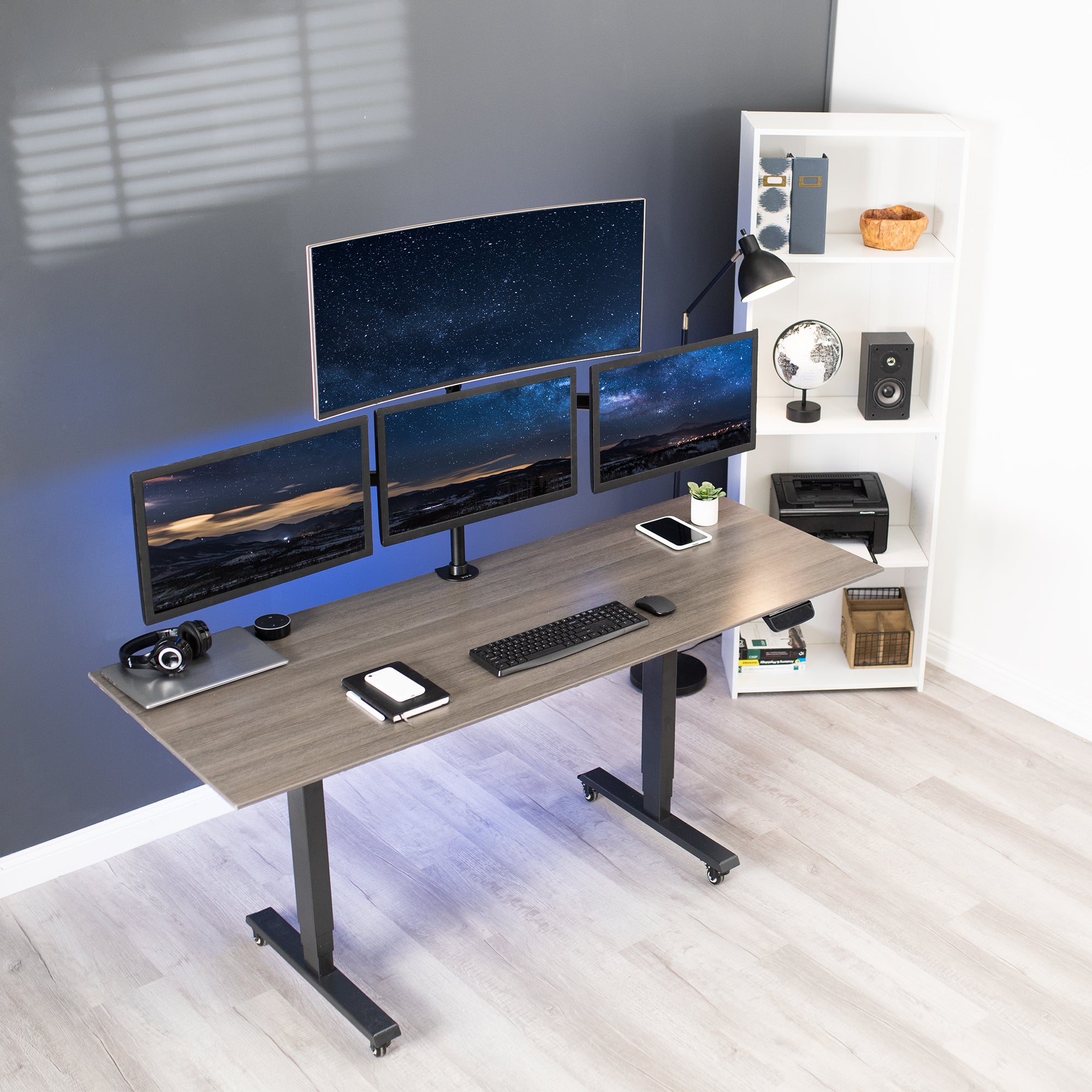 Sturdy height adjustable quad monitor desk stand.