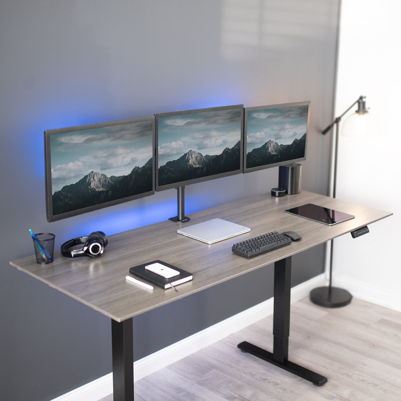 Sturdy flush to wall height adjustable triple monitor desk mount.